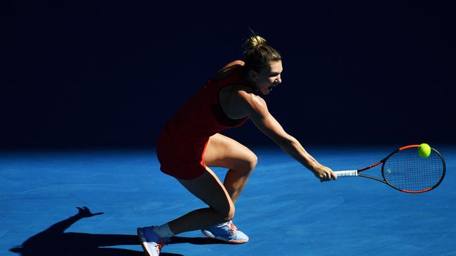 Simona Halep hits a return against Czech Republic's Karolina Pliskova during their women's singles quarter-finals match yesterday. Picture: AFP.