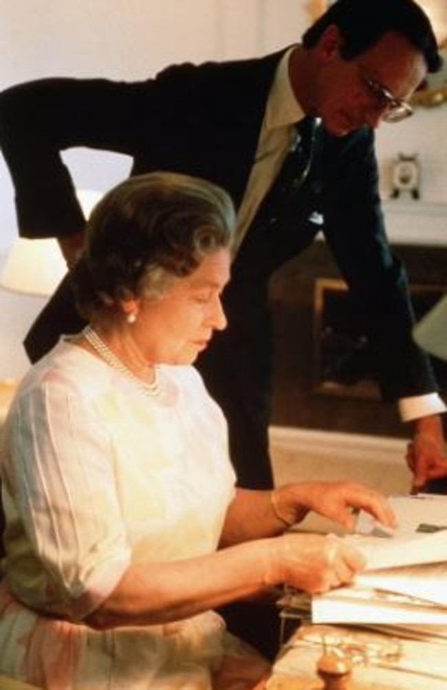 Lord Robert Fellowes and the Queen on board Britannia in the 1980s. Picture: Supplied