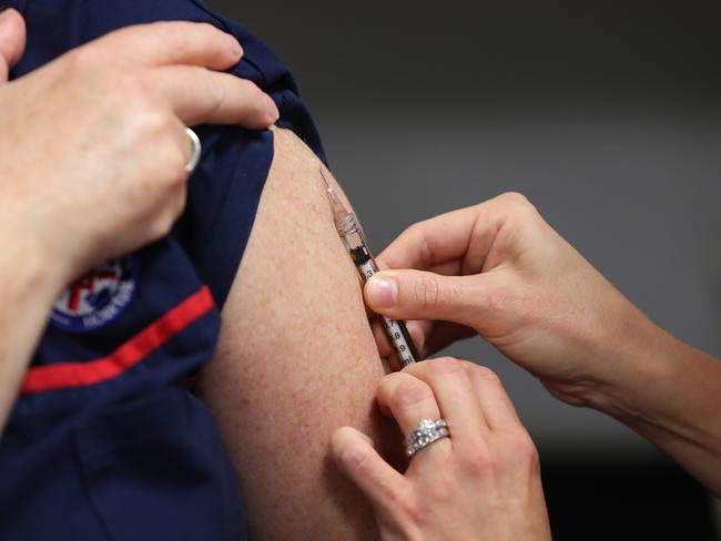 A woman being injected in a separate trial at Sir Charles Gairdner hospital in Perth. The trial includes testing whether an existing tuberculosis vaccine can help reduce the chances of contracting COVID-19. Picture: Paul Kane/Getty