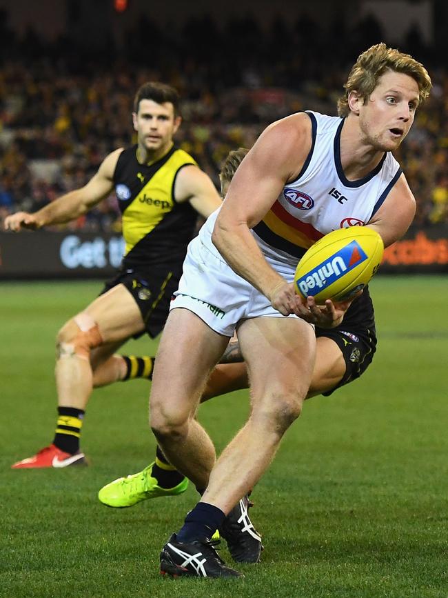 ADELAIDE’S Rory Sloane handballs against the Richmond Tigers at the MCG. Picture: Quinn Rooney/Getty