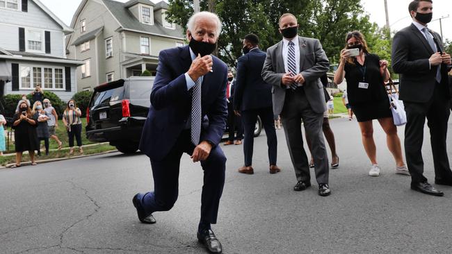 Scent of victory: Democratic fixers test out the latest anti-hair sniffing device on presidential hopeful Joe Biden. Picture: AFP