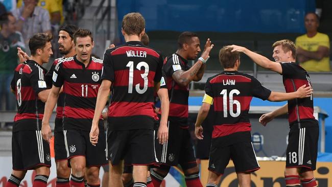 Germany's midfielder Toni Kroos (R) celebrates with teammates.