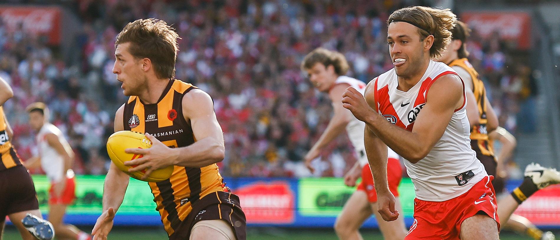 MELBOURNE, AUSTRALIA - APRIL 28: Dylan Moore of the Hawks is chased by James Rowbottom of the Swans during the 2024 AFL Round 07 match between the Hawthorn Hawks and the Sydney Swans at the Melbourne Cricket Ground on April 28, 2024 in Melbourne, Australia. (Photo by Michael Willson/AFL Photos via Getty Images)