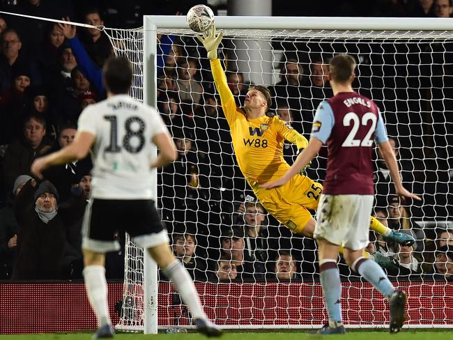 Fulham's Irish midfielder Harry Arter (L) watches as his shot beats the dive of Aston Villa's Norwegian goalkeeper Orjan Nyland for their second goal during the English FA Cup third round football match between Fulham and Aston Villa at Craven Cottage in Fulham, west London on January 4, 2020. (Photo by Glyn KIRK / AFP) / RESTRICTED TO EDITORIAL USE. No use with unauthorized audio, video, data, fixture lists, club/league logos or 'live' services. Online in-match use limited to 120 images. An additional 40 images may be used in extra time. No video emulation. Social media in-match use limited to 120 images. An additional 40 images may be used in extra time. No use in betting publications, games or single club/league/player publications. /