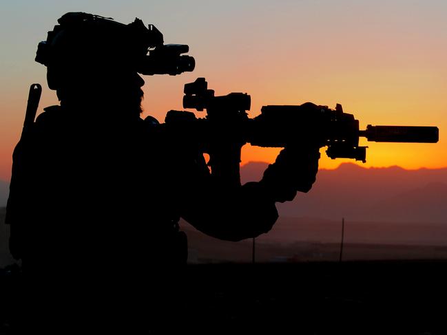 An Australian Army soldier from Special Operations Task Group prepares for a night mission with the Afghan National Security Force's Special Response Team in Uruzgan province, Afghanistan, in October 2010. *** Local Caption *** Australian Army soldiers from Special Operations Task Group mentor Afghan National Security Force police officers from Uruzganâs Special Response Team (SRT) at Multi-National Base Tarin Kowt in southern Afghanistan.   The SRT provides the Afghan government and Uruzgan police with a highly trained capability to tackle the toughest of security and law enforcement missions. The SRT is drawn from Provincial Response Company (PRC) personnel and, typically, deploys on operations alongside their SOTG mentors.  SOTG comprises personnel from the Special Air Service Regiment, 1st and 2nd Commando Regiments, Incident Response Regiment, Special Operations Logistics Squadron and a variety of supporting units from the ADF. Picture: Department of Defence