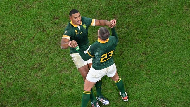 Damian Willemse and Willie Le Roux of South Africa celebrate victory. Photo by Shaun Botterill/Getty Images.