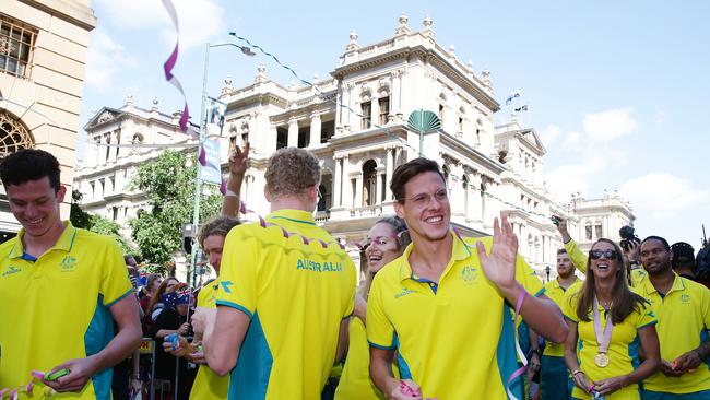 Mitch Larkin waves to supporters at the Commonwealth Games Athletes Parade. Australia was successful on the sporting field but many businesses have a losing feeling. AAP Image/Claudia Baxter