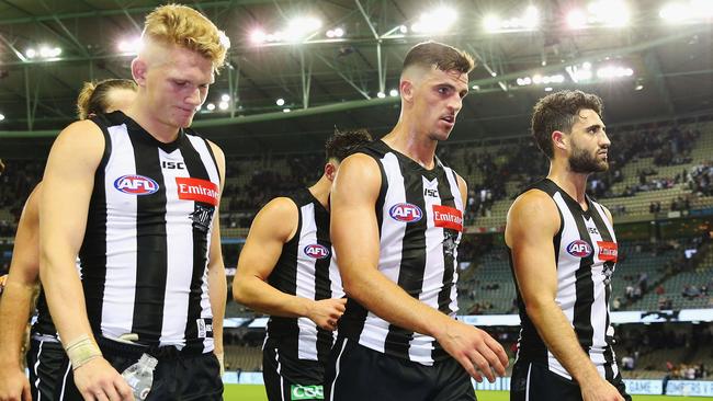 Adam Treloar, Scott Pendlebury, Alex Fasolo. (Photo by Michael Dodge/Getty Images)