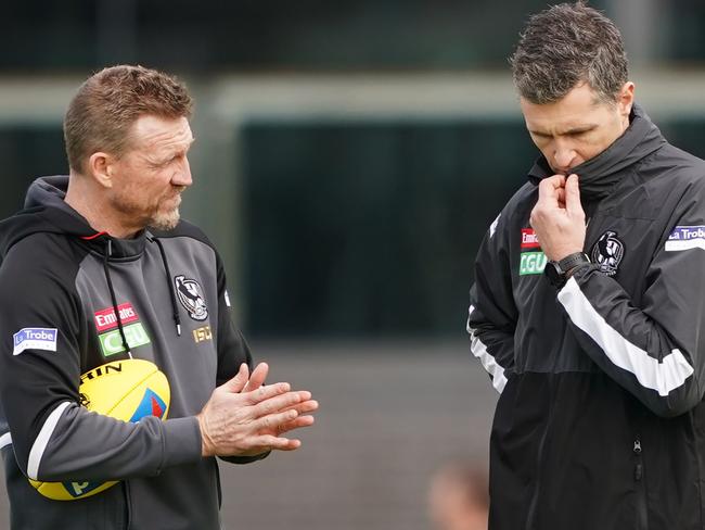 Magpies head coach Nathan Buckley speaks to assistant coach Justin Longmuir during a Collingwood training session in August 2019. Picture: Michael Dodge.