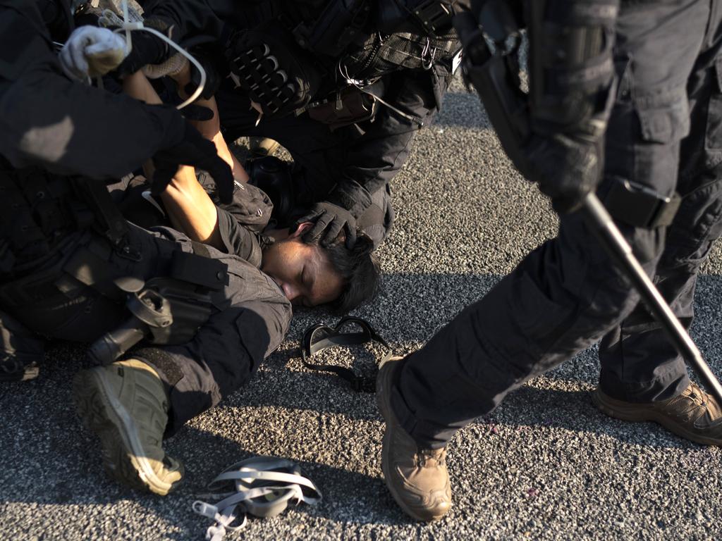 Riot policemen detain a protester in Hong Kong. Picture: AP