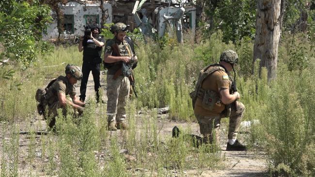 Ukrainian soldiers clear mines from an area that had been infiltrated by Russians.