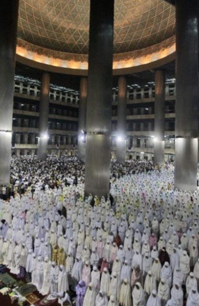 Muslim women perform an evening prayer on the evening of the first eve of the holy fasting month of Ramadan at Istiqlal mosque in Jakarta.