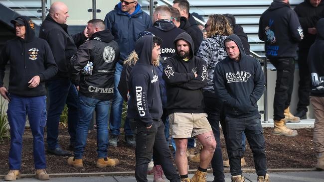 CFMEU members congregate across the road from a construction site the day two tradies were assaulted. Picture: Ian Currie