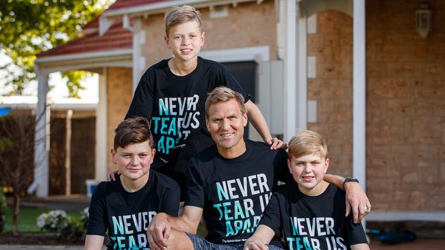 Kane Cornes with his three sons Sonny, standing, Eddy and Raphael, wearing the advertiser's Never Tear us Apart T-shirts in 2020. Picture: Matt Turner.