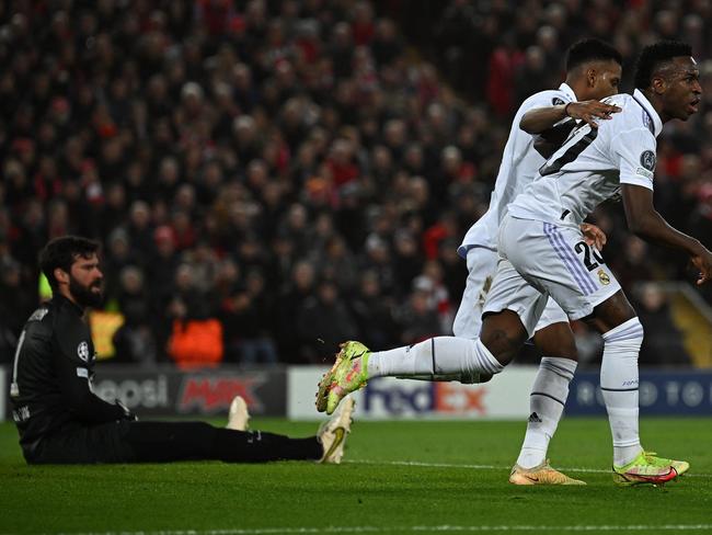 Liverpool's Brazilian goalkeeper Alisson Becker (L) reacts as Real Madrid's Brazilian forward Vinicius Junior (R) c1 during the UEFA Champions League last 16 first leg football match between Liverpool and Real Madrid at Anfield in Liverpool, north west England on February 21, 2023. (Photo by Paul ELLIS / AFP)