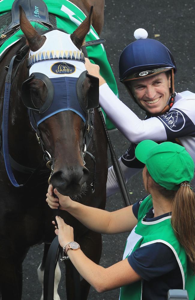 Josh Parr unsaddles Burning Passion after winning the Hall Mark Stakes.