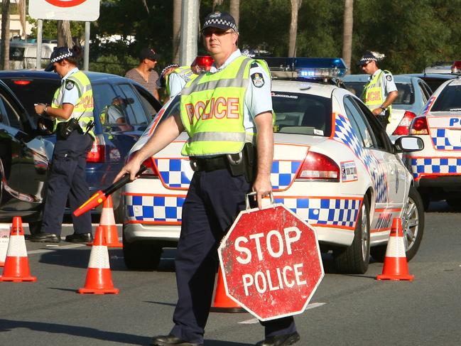 Police Officers during operation Palm Olive random breath testing and drug testing at the Tallebudgera creek section of Gold Coast highway .