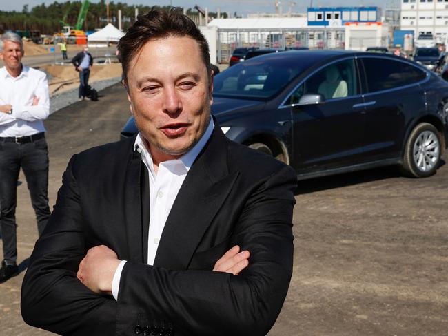 Tesla CEO Elon Musk talks to media as he arrives to visit the construction site of the future US electric car giant Tesla, on September 03, 2020 in Gruenheide near Berlin. - Tesla builds a compound at the site in Gruenheide in Brandenburg for its first European "Gigafactory" near Berlin. (Photo by Odd ANDERSEN / AFP)