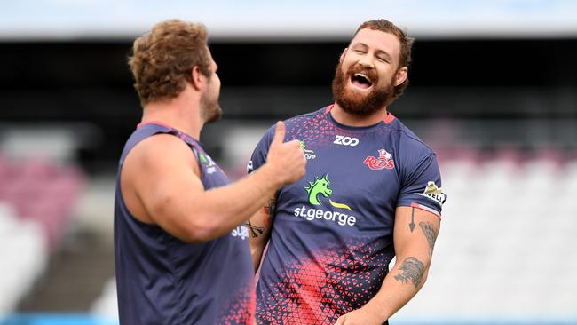 Reds captain Scott Higginbotham shares a laugh with teammate James Slipper.