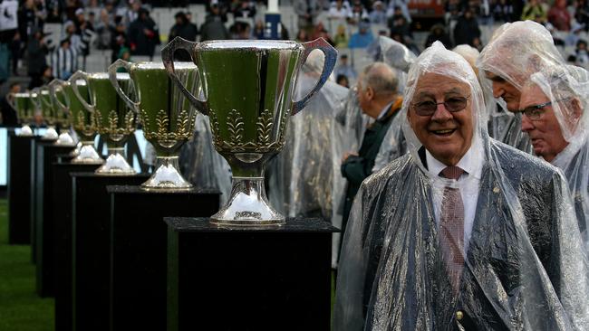 Thorold Merrett among Collingwood greats in ponchos. Picture: Wayne Ludbey