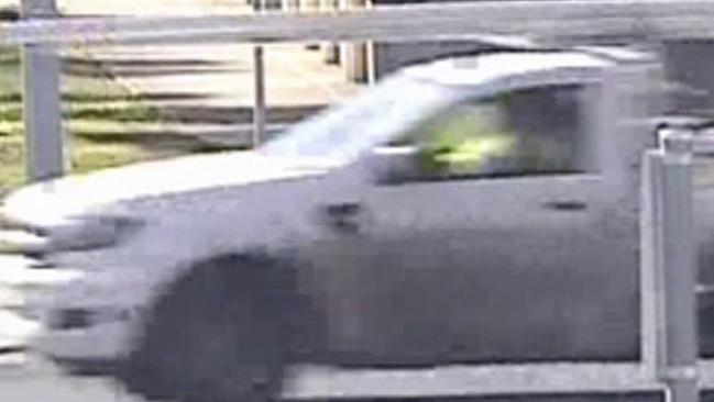 A white Ford ranger singe-cab ute, towing a dual-axle trailer with a yellow mini-excavator on it, was seen around the time the black Mercedes was captured on CCTV. Picture: Victoria Police