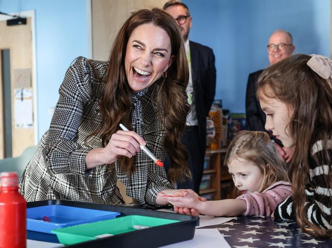 Catherine, Princess of Wales paints the hand of Maggie aged 4 years old whose sibling is being treated at TA Hafan, a children's hospice based in Sully, near Cardiff. Picture: Richard Pohle - WPA Pool/Getty Images