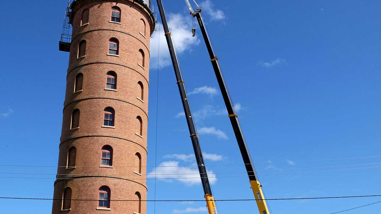 ROOF REMOVAL: Two cranes were used to bring the storm-damaged roof down. Picture: Mike Knott BUN041018TOWER1