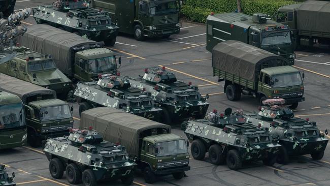 Trucks and armoured personnel carriers are seen parked at the Shenzhen Bay stadium in Shenzhen, bordering Hong Kong in China's southern Guangdong province.