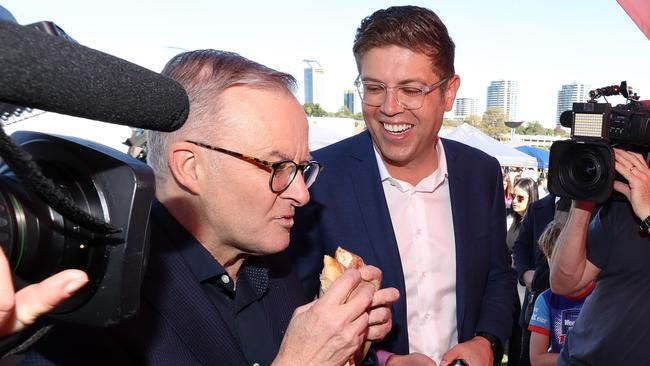 Labor leader Anthony Albanese eats a rhubarb and custard donut during his visit to Ryde Wharf Market, seat of Bennelong, accompanied by Labor’s candidate Jerome Laxale. Picture: Liam Kidston