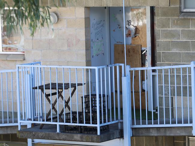 A boarded up broken door at Windsor Court public housing in Glenorchy. Picture: LUKE BOWDEN