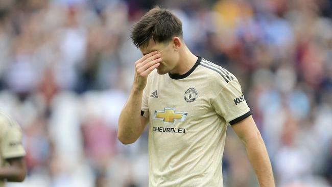 Manchester United's Harry Maguire touches his forehead as he leaves at the end of the English Premier League soccer match between West Ham and Manchester United at London stadium in London, Sunday, Sept. 22, 2019. West Ham beat Manchester United 2-0. (AP Photo/Leila Coker)