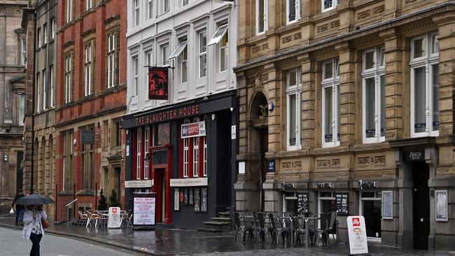 A pedestrian walks past the empty tables of pubs and restaurants in Liverpool, north west England as new local lockdown measures are set to be imposed to help stem a second wave of the novel coronavirus COVID-19. Picture: AFP