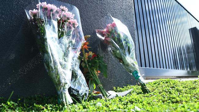 Neighbours of Jamie and Krystel Paul killed in a murder-suicide on Tuesday at Mount Sheridan laid floral tributes at the gate of the Verbena St property. Picture: Peter Carruthers