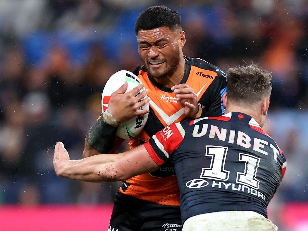 SYDNEY, AUSTRALIA – JUNE 30: Stefano Utoikamanu of the Tigers is tackled by the Roosters defence during the round 17 NRL match between Sydney Roosters and Wests Tigers at Allianz Stadium, on June 30, 2024, in Sydney, Australia. (Photo by Brendon Thorne/Getty Images)