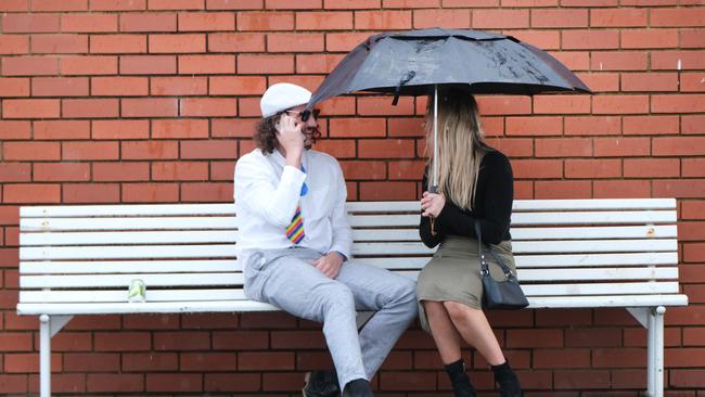 In the aftermath of the Geelong Cup, punters were shielding themselves from the wet weather. Picture: Mark Wilson