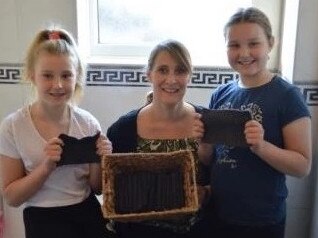 Kelsey poses with her girls and her homemade loo roll. Picture: Lily Canter/Collect