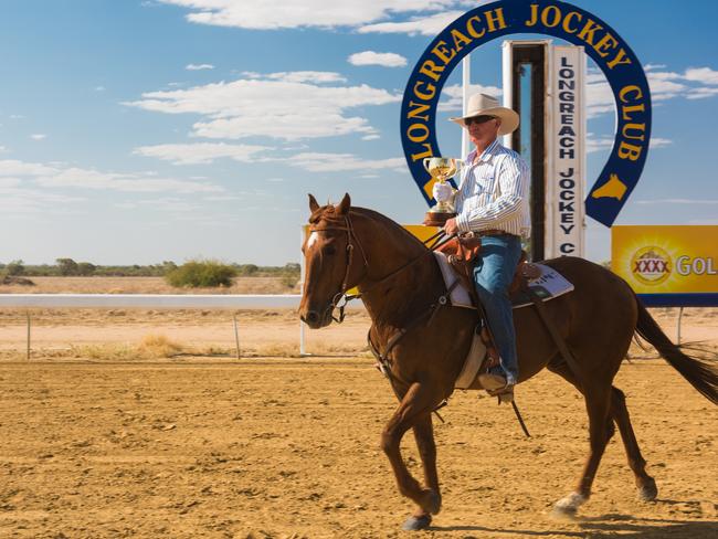 The Emirates Melbourne Cup being brought to the Longreach Cup Day presentation.