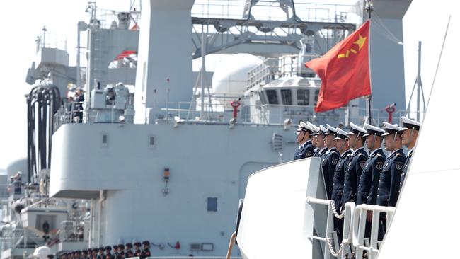 Officers and soldiers of the Chinese naval fleet for escort mission line up on the deck at a port in Zhoushan, east China. Military lessons from the Ukraine war are being absorbed quickly in Asia.