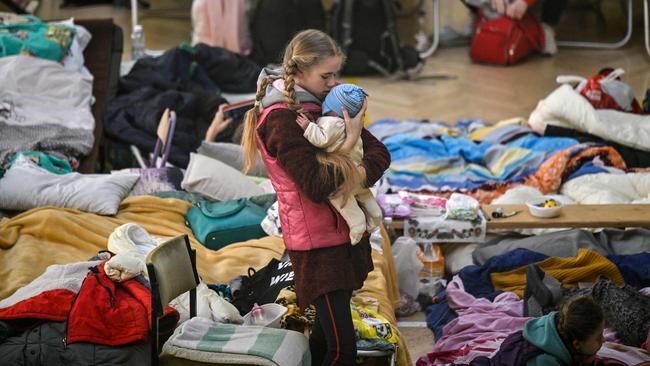 A girl holds her baby sibling in a shelter for Ukrainian refugees in a school in Przemysl, near the Ukrainian-Polish border. Picture: AFP