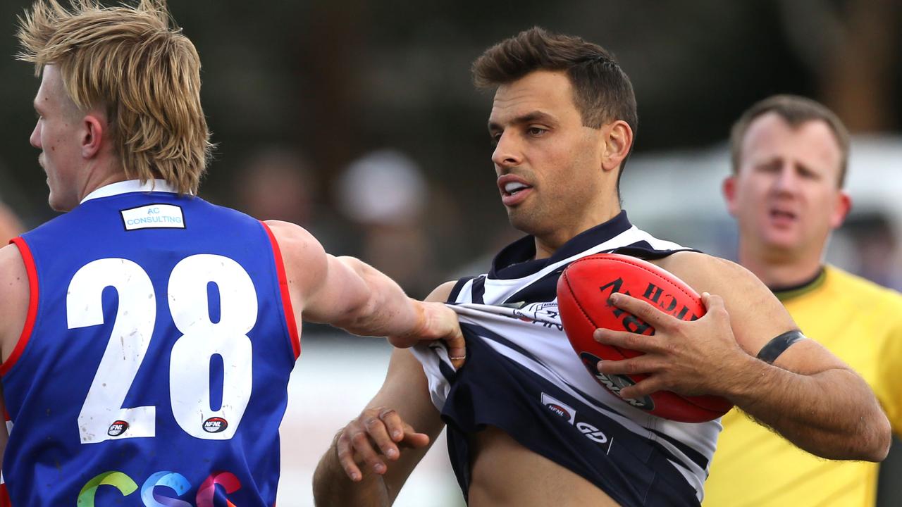 Northern: Bundoora star Sam Lloyd is held up by Jared Crosbie of North Heidelberg. Picture: Stuart Milligan