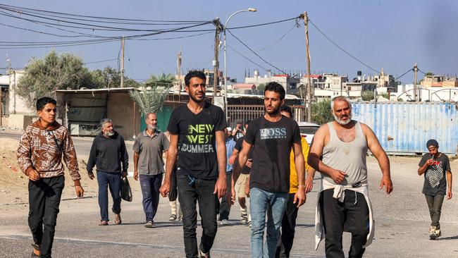 Palestinian workers, who were stranded in Israel since the October 7 attacks, cross back into the Gaza Strip at the Kerem Shalom commercial border crossing.