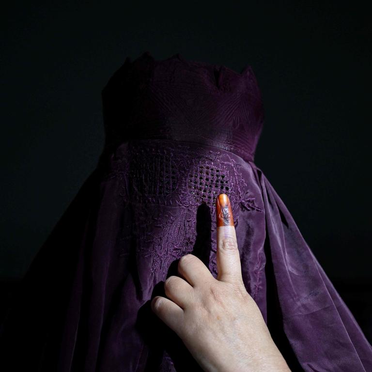 A burqa-clad woman shows her inked finger after casting her ballot to vote in the first phase of India's general election. Picture: Sajjad Hussain/AFP