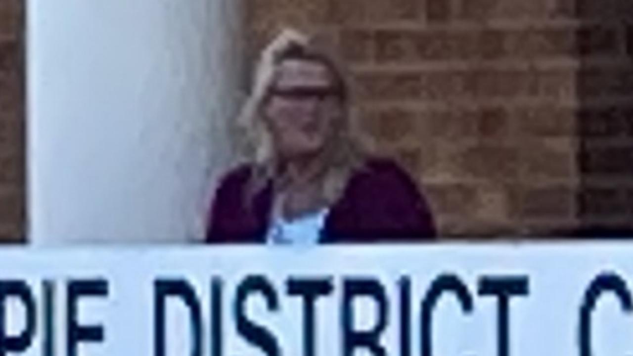 Kay Lorraine Menzies (maroon jumper) leaves Gympie District Court.