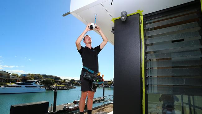 Jacob Nicholson from Electronic Living installs security cameras at a property in Cleveland. Picture: David Clark.