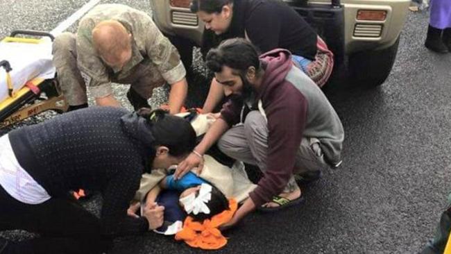 Uses turban to cradle the poor child's head ... Sikh student Harman Singh broke strict religious protocol to give aid and has been heavily praised. Picture: Twitter