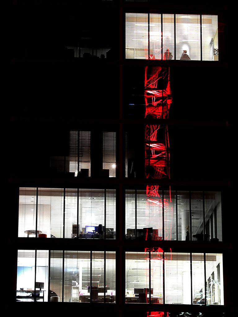 Paint The Town Red. The 10 Murray St crane reflected in the new government building in Salamanca. Picture: SAM ROSEWARNE.