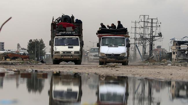 Displaced Palestinians drive in the central Gaza Strip. Picture: AFP.