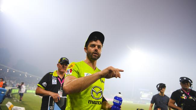 Callum Ferguson of the Sydney Thunder as smoke haze forced the stoppage of play during the Big Bash League cricket match between the Sydney Thunder and the Adelaide Strikers at Manuka Oval in Canberra on Saturday. Picture: AAP