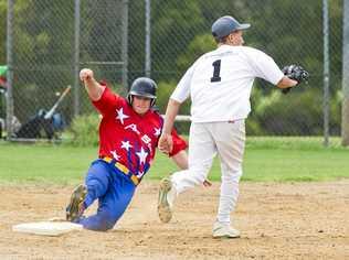 STATE DUTIES: Lewis Codd (left) slides safely into first base. Codd has been named in the Queensland Patriots team competing at the Australian championships. Picture: Nev Madsen