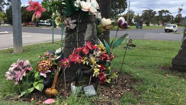 A makeshift memorial at the scene of the incident at a Nambucca shopping centre carpark.